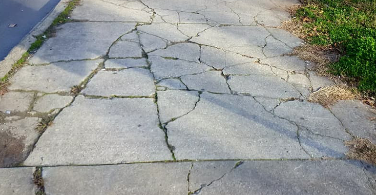 Badly Cracked and damaged sidewalk
